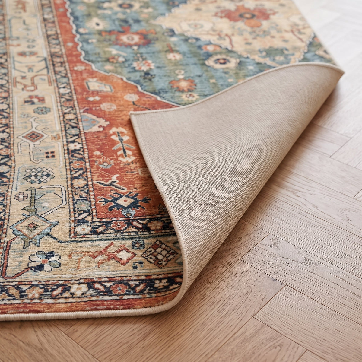 Amira Persian-style rug, folded corner showing the low pile and non-slip backing