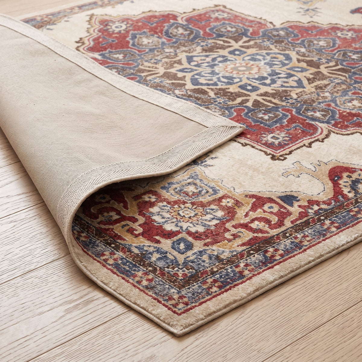 Aurelia Persian-style rug, folded corner showing the low pile and non-slip backing