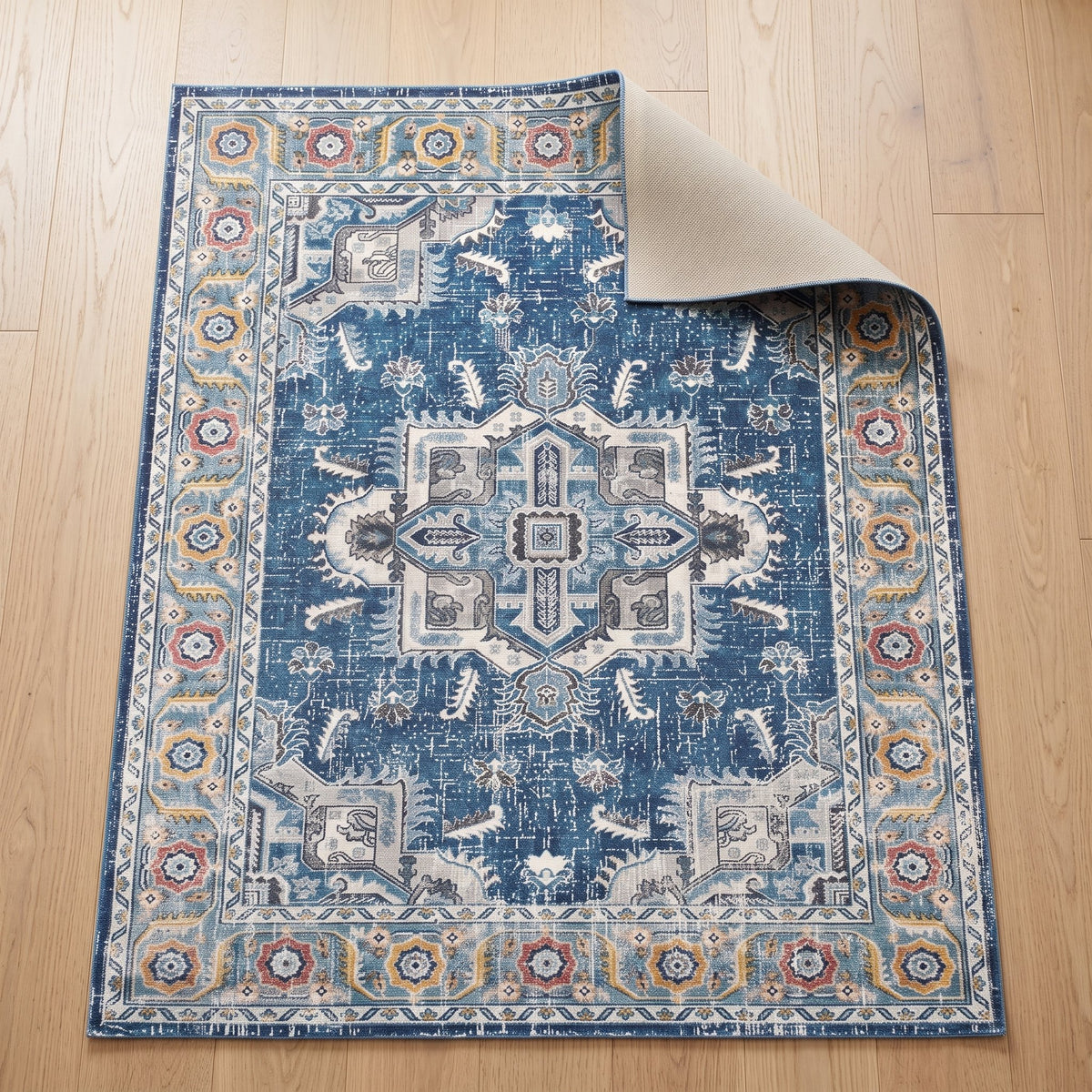 Azure Persian-style rug with one corner turned back to show the non-slip backing