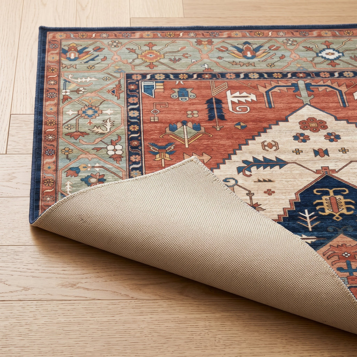 Marlow Persian-style rug, folded corner showing the low pile and non-slip backing
