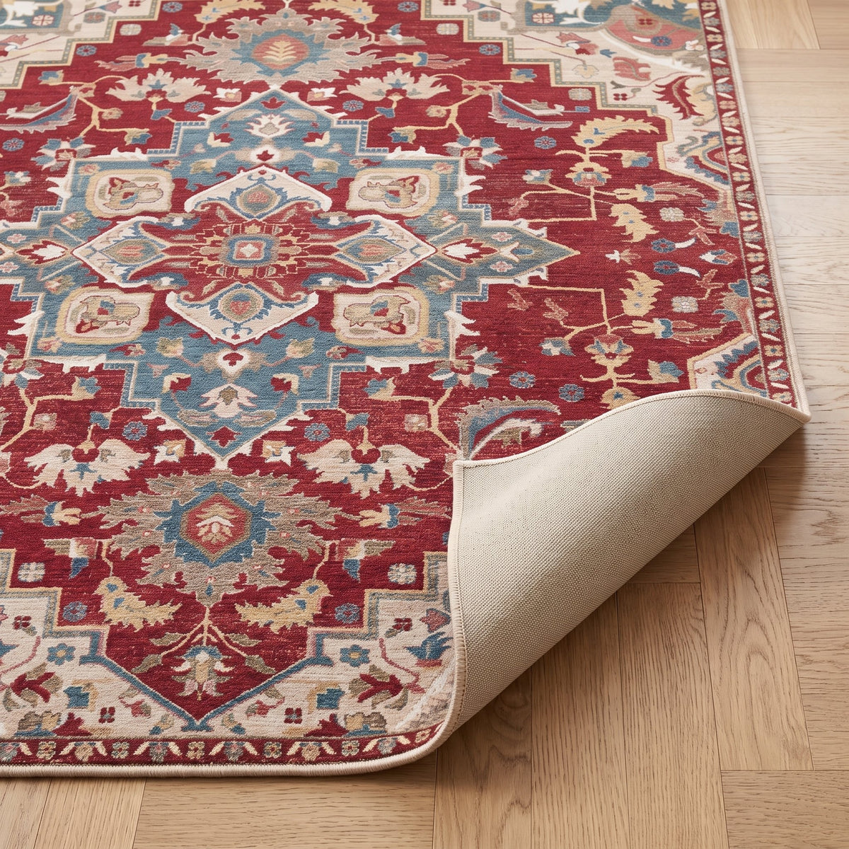 Ruby Persian-style rug with one corner turned back to show the non-slip backing